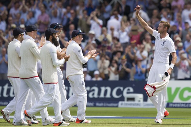 England's Stuart Broad, right, is appalauded by teammates  as he raises the ball after taking 8 wickets for 15 runs as Australia are bowled out for 60 before lunch on the first day of the fourth Ashes test cricket match between England and Australia at Trent Bridge cricket ground in Nottingham, England, Thursday, Aug. 6, 2015. (AP Photo/Jon Super)