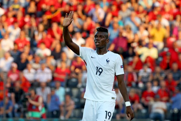 French player Paul Pogba waves to the crowd during the match between Albania and France in their friendly soccer match in the central city of Elbasan, 50 kilometers (30 miles) south of the capital Tirana, Saturday, June 13, 2015. (AP Photo/Hektor Pustina)