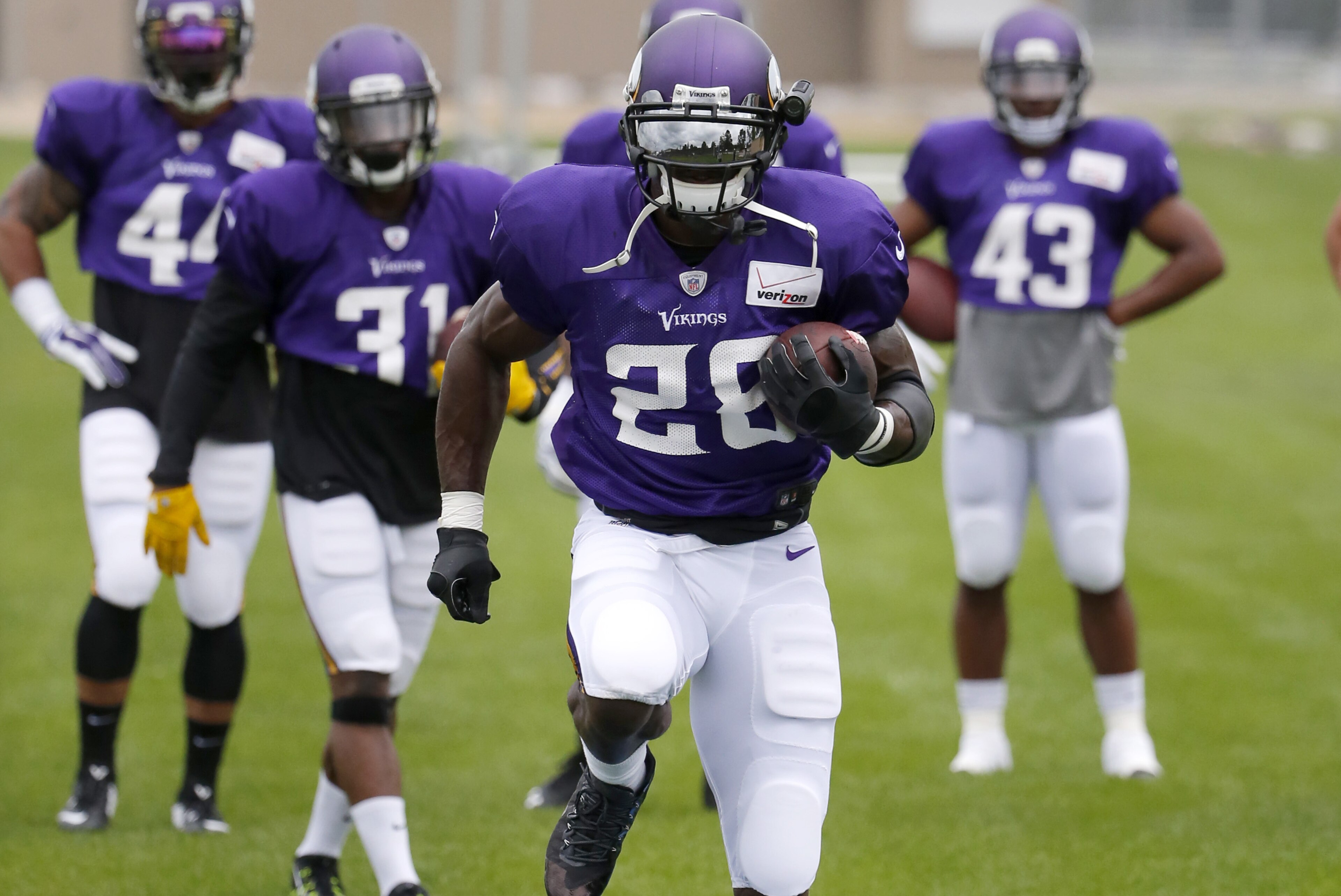 Minnesota Vikings running back Adrian Peterson (28) leads his teammates in a drill during the first practice in full pads at an NFL football training camp on the campus of Minnesota State University Tuesday, July 28, 2015, in Mankato, Minn. (AP Photo/Charles Rex Arbogast)