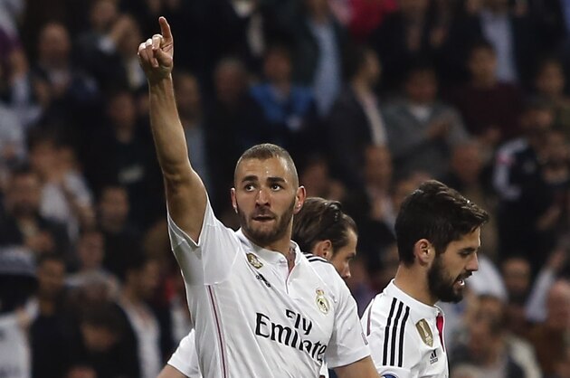 Real Madrid's Karim Benzema celebrates scoring his side's 3rd goal during a Champions League soccer match round of 16 second leg, between Real Madrid and Schalke 04 at Santiago Bernabeu stadium, in Madrid, Spain, Tuesday, March 10, 2015. (AP Photo/Andres Kudacki)