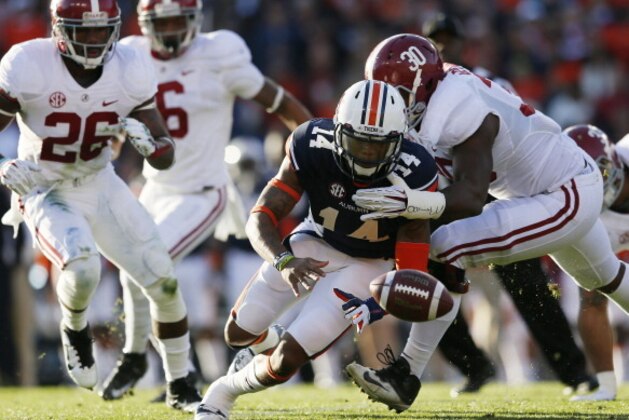AUBURN, AL - NOVEMBER 30:  Nick Marshall #14 of the Auburn Tigers recovers his fumble against the defense of Denzel Devall #30 of the Alabama Crimson Tide in the first quarter at Jordan-Hare Stadium on November 30, 2013 in Auburn, Alabama.  (Photo by Kevin C. Cox/Getty Images)
