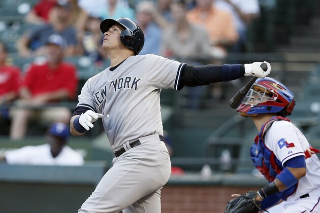 New York Yankees' Alex Rodriguez follows through on a swing as Texas Rangers' Robinson Chirinos watches in the first inning of a baseball game Wednesday, July 29, 2015, in Arlington, Texas. (AP Photo/Tony Gutierrez)
