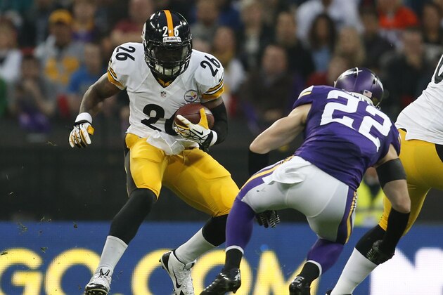 Pittsburgh Steelers running back Le'Veon Bell, left, runs with the ball before being brought down by Minnesota Vikings safety Harrison Smith, 22, during the NFL football game against  at Wembley Stadium, London, Sunday, Sept. 29, 2013.  (AP Photo/Matt Dunham)