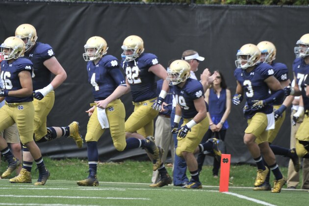 Notre Dame players run onto the field before the Blue Gold game Saturday April 18, 2015 in South Bend, Ind. (AP Photo/Joe Raymond)