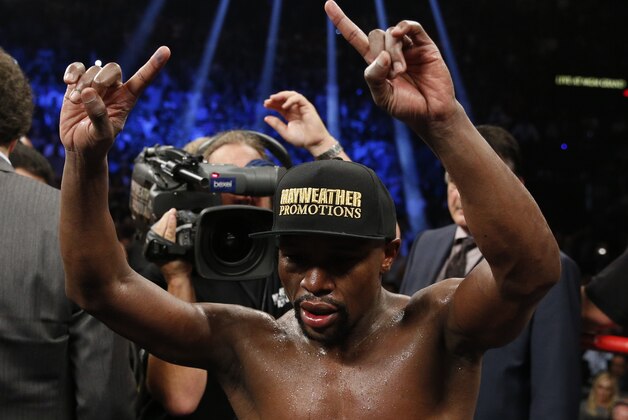 Floyd Mayweather Jr. celebrates after his welterweight title fight against Manny Pacquiao, from the Philippines, on Saturday, May 2, 2015 in Las Vegas.(AP Photo/John Locher)