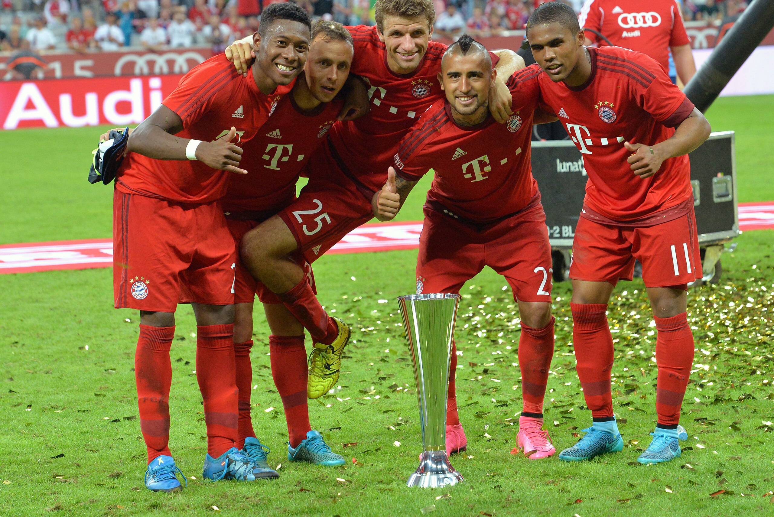 Bayern Munich players celebrate with the trophy after winning the friendly soccer match against Real Madrid in the Allianz Arena stadium in Munich, southern Germany, Wednesday, Aug. 5, 2015. (AP Photo/Kerstin Joensson)