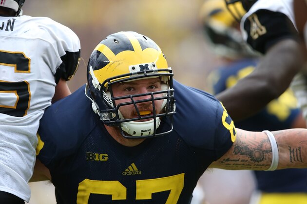 ANN ARBOR, MI - AUGUST 30: Kyle Kalis #67 of the Michigan Wolverines blocks during an extra point attempt during the first half of the game against Appalachian State at Michigan Stadium on August 30, 2014 in Ann Arbor, Michigan.  (Photo by Leon Halip/Getty Images)