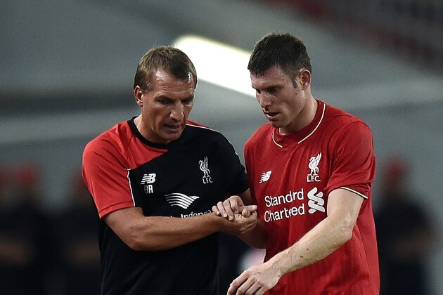 Liverpool's English midfielder James Milner (R) shakes hands with manager Brendan Rodgers during their friendly football match at the Bukit Jalil Stadium in Kuala Lumpur on July 24, 2015.    AFP PHOTO / MANAN VATSYAYANA        (Photo credit should read MANAN VATSYAYANA/AFP/Getty Images)