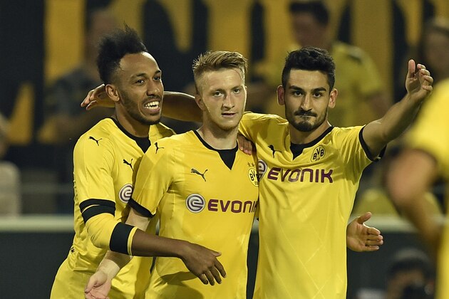 Dortmund's Marco Reus, center, is celebrated by Pierre-Emerick Aubameyang from Gabon, left, and Ilkay Gundogan, right, after scoring the opening goal during the Europa League qualifying soccer match between Borussia Dortmund and Wolfsberger AC in Dortmund, Germany, Thursday, Aug. 6, 2015. (AP Photo/Martin Meissner)