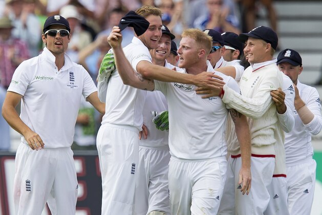 England's Stuart Broad, second left, celebrates with teammates after taking the wicket of Australia's Steven Smith, caught by Ben Stokes, centre, for 5 on the second day of the fourth Ashes test cricket match between England and Australia at Trent Bridge cricket ground in Nottingham, England, Friday, Aug. 7, 2015. (AP Photo/Jon Super)