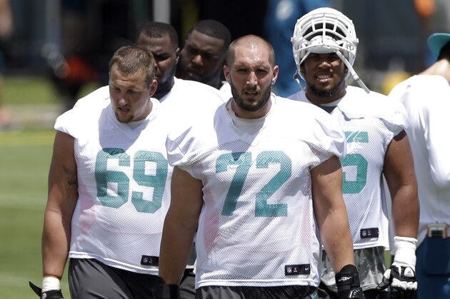Miami Dolphins' Jeff Linkenbach (72) Michael Liedtke (69) and Jamil Douglas, right, head to a drill during NFL football minicamp,   Wednesday, June 17, 2015, in Davie, Fla. (AP Photo/Alan Diaz)