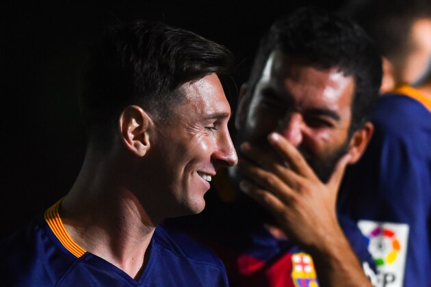 BARCELONA, SPAIN - AUGUST 05:  Lionel Messi (L) and Arda Turan of FC Barcelona  share a joke during the team official presentation ahead of the Joan Gamper trophy match at Camp Nou on August 5, 2015 in Barcelona, Spain.  (Photo by David Ramos/Getty Images)