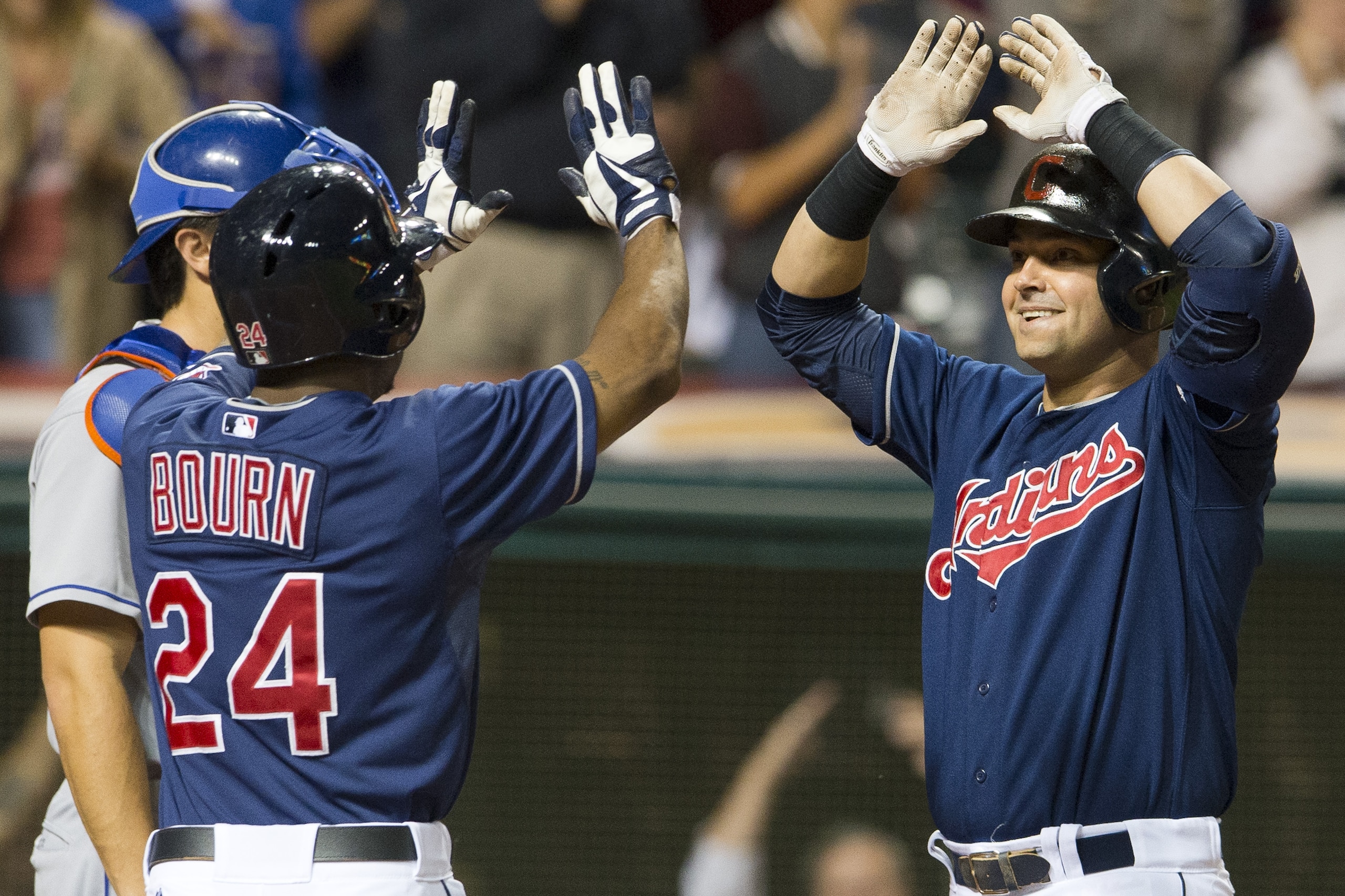CLEVELAND, OH - SEPTEMBER 6: Michael Bourn #24 of the Cleveland Indians celebrates with Nick Swisher #33 after Swisher hit a grand slam during the eighth inning against the New York Mets at Progressive Field on September 6, 2013 in Cleveland, Ohio. (Photo by Jason Miller/Getty Images)