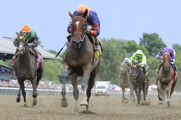 One Minute, jockey Joel Rosario up, center, pulls away to win the Schuylerville Stakes on opening day of the horse racing season at Saratoga Race Course in Saratoga Springs, N.Y., Friday, July 24, 2015. (AP Photo/Hans Pennink)