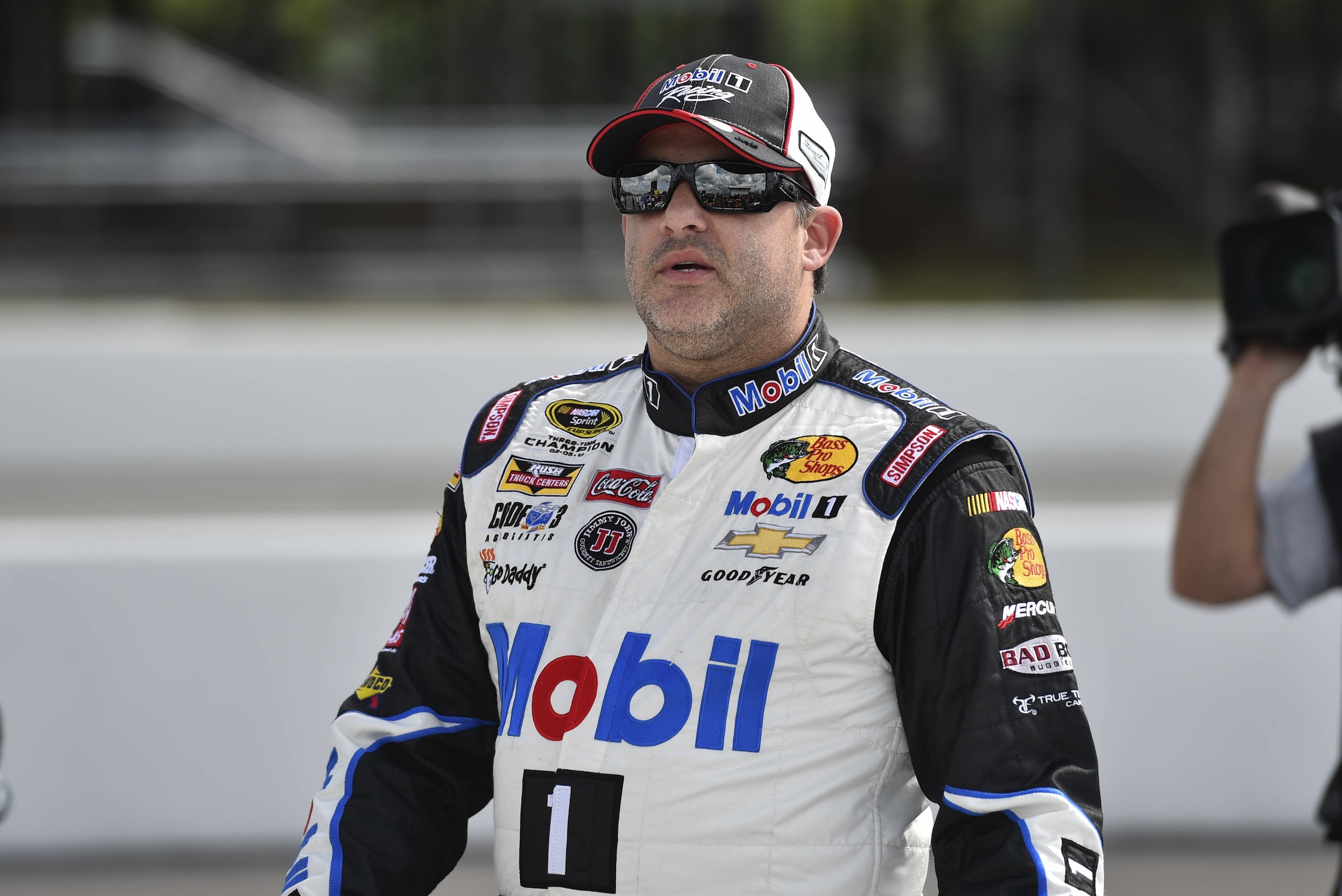 Tony Stewart (14) walks along on pit row at Pocono Raceway in preparation for Sunday's NASCAR Sprint Cup Series auto race in Long Pond, Pa., Friday, June 5, 2015. (AP Photo/Mel Evans)