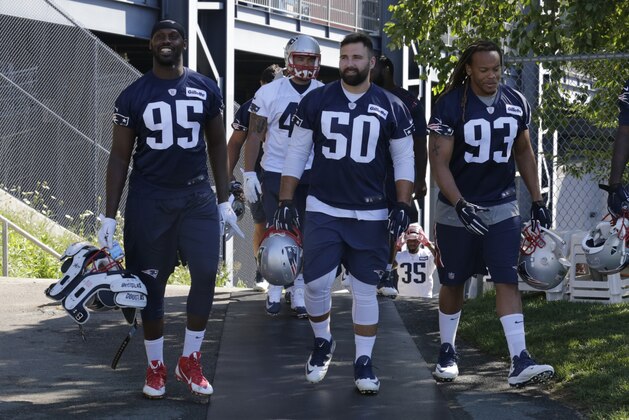 New England Patriots defensive lineman head to the practice field during an NFL football training camp in Foxborough, Mass., Friday, July 31, 2015.  From left are Chandler Jones (95), Rob Ninkovich (50), Jabaal Sheard (93) and Zach Moore (90). (AP Photo/Charles Krupa)