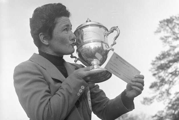 Louise Suggs of Sea Island, Ga., holds aloft the winner's cup and a $1,000 check after winning the Women's Titleholders Golf Championship at Augusta, Ga., March 15, 1959.  (AP Photo/Horace Cort)