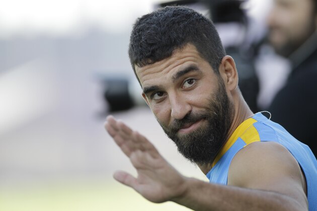 FC Barcelona's Arda Turan gestures during the first training session of the 2015-2016 football season at the Sports Center FC Barcelona Joan Gamper in the San Joan Despi, Spain, Monday, July 13, 2015. (AP Photo/Manu Fernandez)