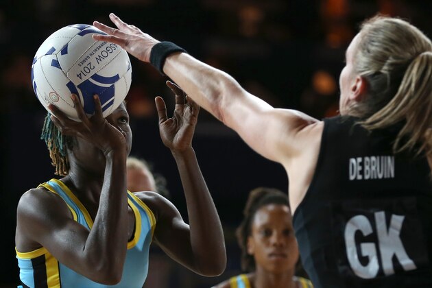Shem Maxwell, left, of St Lucia takes a free shot on goal as Leana De Bruin puts up a hand to block during their preliminary round netball match at the Commonwealth Games Glasgow 2014, in Glasgow, Scotland, Tuesday, July, 29, 2014. (AP Photo/Alastair Grant)