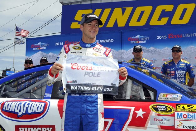 AJ Allmendinger poses with the pole award after qualifying for Sunday's NASCAR Sprint Cup series auto race at Watkins Glen International, Saturday, Aug. 8, 2015, in Watkins Glen. N.Y. (AP Photo/Derik Hamilton)