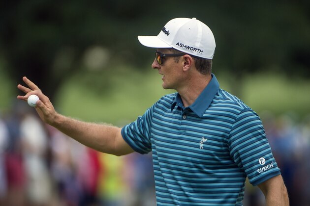 Justin Rose, of England, reacts after making a birdie on the first hole during the third round of the Bridgestone Invitational golf tournament in Akron, Ohio, Saturday, Aug. 8, 2015. (AP Photo/Phil Long)