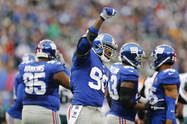 New York Giants defensive end Jason Pierre-Paul (90) reacts after a delay of game penalty during the first half of an NFL football game against the Philadelphia Eagles Sunday, Dec. 28, 2014, in East Rutherford, N.J. (AP Photo/Julio Cortez)