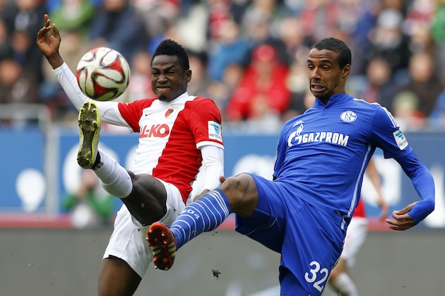 Augsburg's Abdul Rahman Baba from Ghana, left, and Schalke's Joel Matip from Cameroon challenge for the ball during the German first division Bundesliga soccer match between FC Augsburg and FC Schalke 04 in the SGL Arena in Augsburg, Germany, on Sunday, April 5, 2015. (AP Photo/Matthias Schrader)