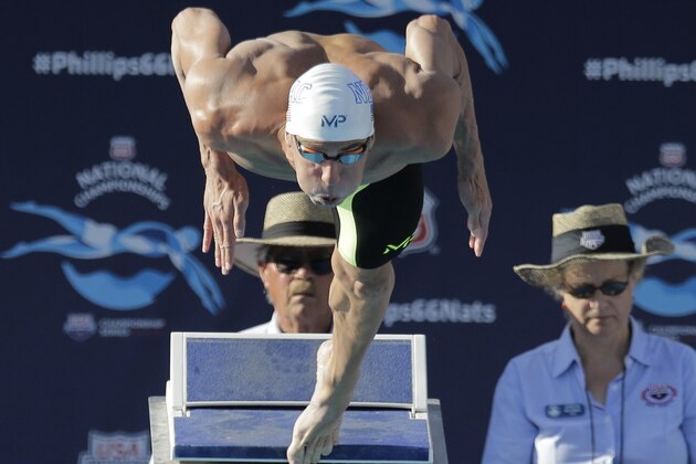 Michael Phelps dives into the pool at the start of the men's 100-meter butterfly final at the the U.S. swimming nationals, Saturday, Aug. 8, 2015, in San Antonio. Phelps won the race. (AP Photo/Eric Gay)