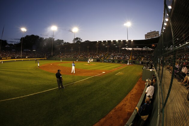 The sunsets on Lamade Stadium during a baseball game between Philadelphia and Pearland in United States pool play at the Little League World Series tournament in South Williamsport, Pa., Sunday, Aug. 17, 2014. Philadelphia won 7-6. (AP Photo/Gene J. Puskar)