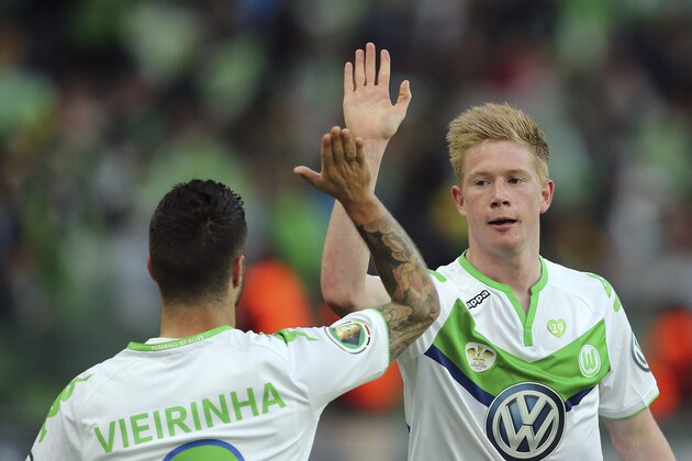 Wolfsburg's Kevin De Bruyne from Belgium, right, and Wolfsburg's Vieirinha from Portugal celebrate after scoring during the German soccer cup final match between Borussia Dortmund and VfL Wolfsburg in Berlin, Germany, Saturday, May 30, 2015. (AP Photo/Markus Schreiber)