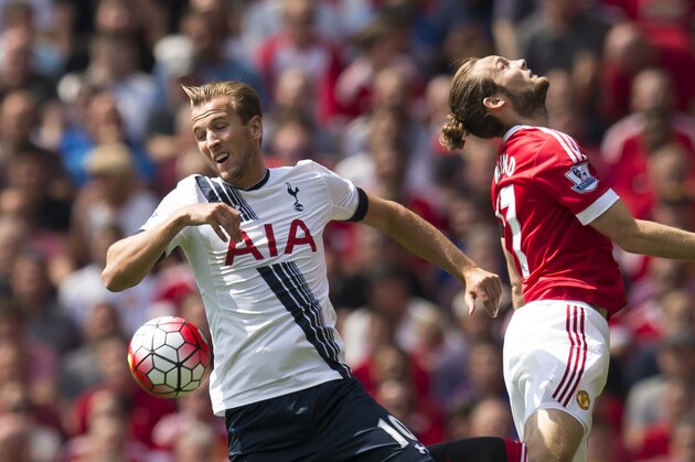 Manchester United's Daley Blind, right, fights for the ball against Tottenham's Harry Kane during the English Premier League soccer match between Manchester United and Tottenham at Old Trafford Stadium, Manchester, England, Saturday, Aug. 8, 2015. (AP Photo/Jon Super)