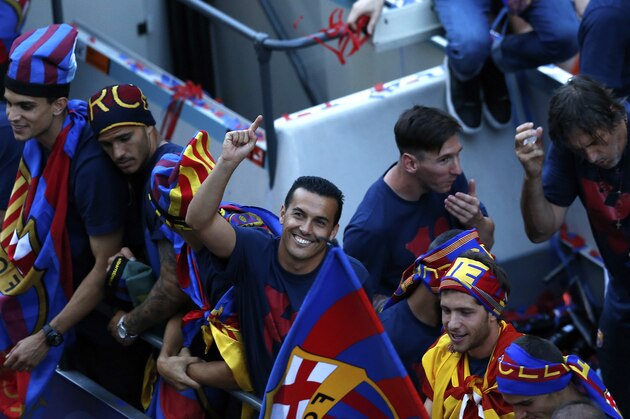 Barcelona's Pedro, center, celebrates on the team bus during celebrations in Barcelona, Spain Sunday June 7, 2015 after winning the Champions League final soccer match Saturday by beating Juventus Turin 3-1. Barcelona won the triple this season winning the Spanish League title, the Copa del Rey and the Champions League. (AP Photo/Manu Fernandez)