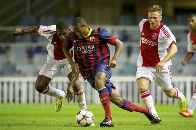(L-R) Elton-Ofoi Acolatse of Ajax U19, Adama Traore of FC Barcelona U19, Melvin Vissers of Ajax U19 during the UEFA Youth League match between Barcelona and Ajax on September 17, 2013 at Barcelona, Spain.(Photo by VI Images via Getty Images)
