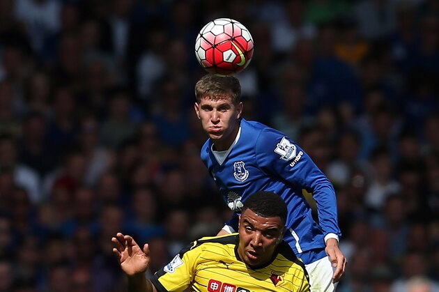 LIVERPOOL, ENGLAND - AUGUST 08: John Stones of Everton in action with Troy Deeney of Watford during the Barclays Premier League match between Everton and Watford at Goodison Park on August 8, 2015 in Liverpool, England. (Photo by Chris Brunskill/Getty Images)