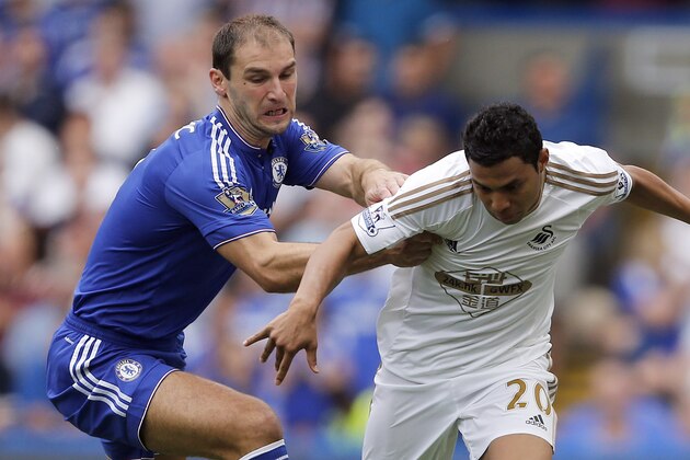 Chelsea's Branislav Ivanovic, left, and Swansea's Jefferson Montero challenge for the ball during the English Premier League soccer match between Chelsea and Swansea City at Stamford Bridge stadium in London, Saturday, Aug. 8, 2015. (AP Photo/Frank Augstein)