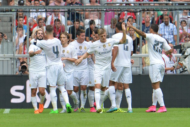 Madrid's players celebrate after scoring during  their friendly soccer match between  Real Madrid and Tottenham Hotspur, in the Allianz Arena stadium in Munich, southern Germany, Tuesday, Aug. 4, 2015. (AP Photo/Kerstin Joensson)