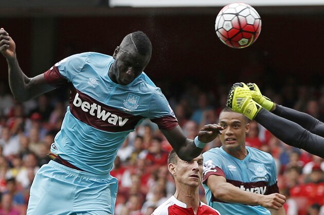 West Ham United's Senegalese midfielder Cheikhou Kouyate (L) scores the opening goal of the English Premier League football match between Arsenal and West Ham United at the Emirates Stadium in London on August 9, 2015. AFP PHOTO / ADRIAN DENNIS

RESTRICTED TO EDITORIAL USE. No use with unauthorized audio, video, data, fixture lists, club/league logos or 'live' services. Online in-match use limited to 75 images, no video emulation. No use in betting, games or single club/league/player publications.        (Photo credit should read ADRIAN DENNIS/AFP/Getty Images)