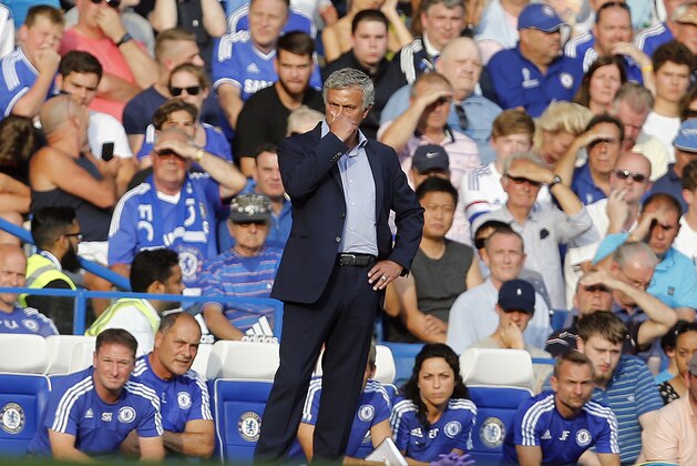Chelsea's manager Jose Mourinho covers his face during the English Premier League soccer match between Chelsea and Swansea City at Stamford Bridge stadium in London, Saturday, Aug. 8, 2015.(AP Photo/Frank Augstein)