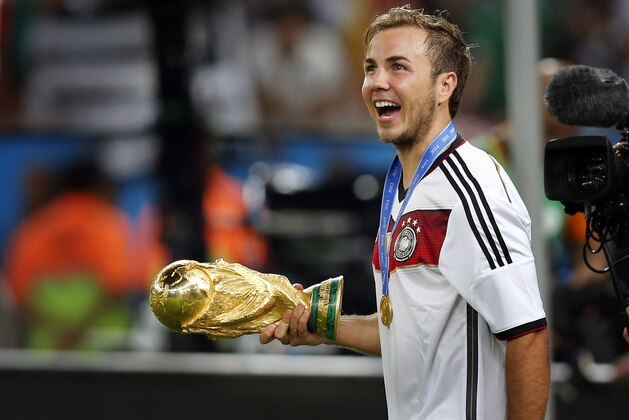Germany's Mario Goetze holds the trophy after the World Cup final soccer match between Germany and Argentina at the Maracana Stadium in Rio de Janeiro, Brazil, Sunday, July 13, 2014. Germany beat Argentina 1-0 to win the World Cup. (AP Photo/Frank Augstein)