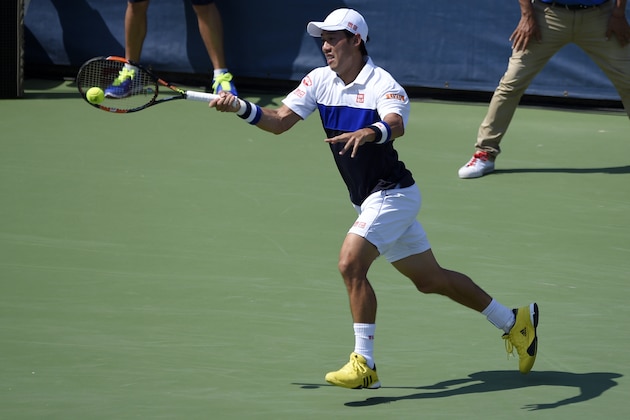 Kei Nishikori, of Japan, returns the ball against John Isner during a men's singles final match at the Citi Open tennis tournament, Sunday, Aug. 9, 2015, in Washington. (AP Photo/Nick Wass)
