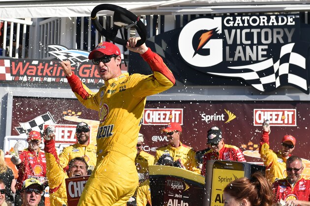 Joey Logano celebrates in Victory Lane after winning a NASCAR Sprint Cup series auto race at Watkins Glen International, Sunday, Aug. 9, 2015, in Watkins Glen. N.Y. (AP Photo/Derik Hamilton)