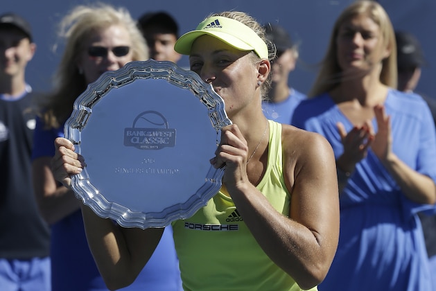 Angelique Kerber, from Germany, kisses the trophy after beating Karolina Pliskova, from Czech Republic, in the championship match in the Bank of the West Classic tennis tournament in Stanford, Calif., Sunday, Aug. 9, 2015. Kerber won 6-3, 5-7, 6-4. (AP Photo/Jeff Chiu)