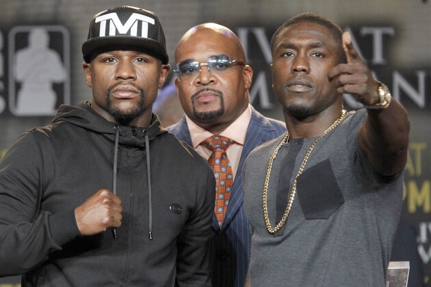 Boxers, Floyd Mayweather, Jr., left, and Andre Berto, right, pose for a photo at a news conference in Los Angeles on Thursday, Aug. 6, 2015. Mayweather Promotions, CEO Leonard Ellerbe, middle. Mayweather says Berto is a worthy opponent for the final fight of his perfect career. Three months after Mayweather dominated Manny Pacquiao in the most lucrative fight in boxing history, he began the difficult business of promoting his pay-per-view bout with Berto with a news conference in downtown Los Angeles. (AP Photo/Nick Ut)