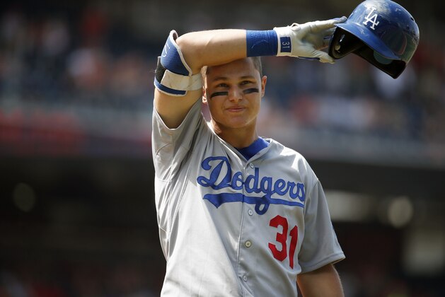 Los Angeles Dodgers center fielder Joc Pederson (31) wipes his brow during his at bat in the ninth inning of a resumed baseball game against the Washington Nationals at Nationals Park, Saturday, July 18, 2015, in Washington. The game was resumed in the top of the sixth inning after it was suspended July 17 due to a problem with the lights.  The Nationals won 5-3. (AP Photo/Alex Brandon)