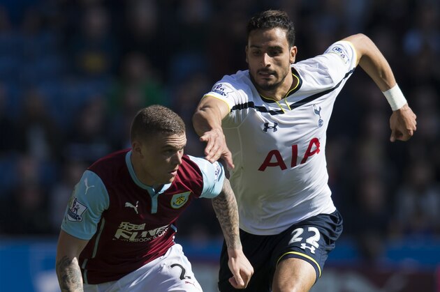 Burnley's Kieran Trippier, left, fights for the ball against Tottenham's Nacer Chadli during the English Premier League soccer match between Burnley and Tottenham at Turf Moor Stadium, Burnley, England, Sunday April 5, 2015. (AP Photo/Jon Super)