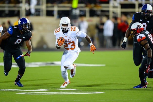 LUBBOCK, TX - NOVEMBER 1: Daje Johnson #23 of the Texas Longhorns runs the ball against the Texas Tech Red Raiders on November 1, 2014 at Jones AT&T Stadium in Lubbock, Texas. Texas won the game 34-13. (Photo by John Weast/Getty Images)