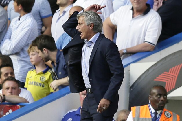 Chelsea manager José Mourinho shouts across the pitch as Chelsea’s Eden Hazard lies apparently injured following a foul during the English Premier League soccer match between Chelsea and Swansea City at Stamford Bridge, London, Saturday Aug. 8, 2015. (AP Photo/Tim Ireland)