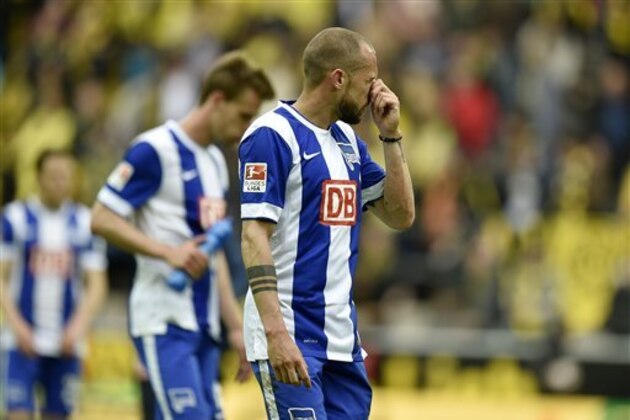 Berlin's John Heitinga from the Netherlands levaes the pitch disappointed after losing the German first division Bundesliga soccer match between Borussia Dortmund and Hertha BSC Berlin in Dortmund, Germany, Saturday, May 9, 2015. Dortmund defeated Berlin with 2-0. (AP Photo/Martin Meissner)