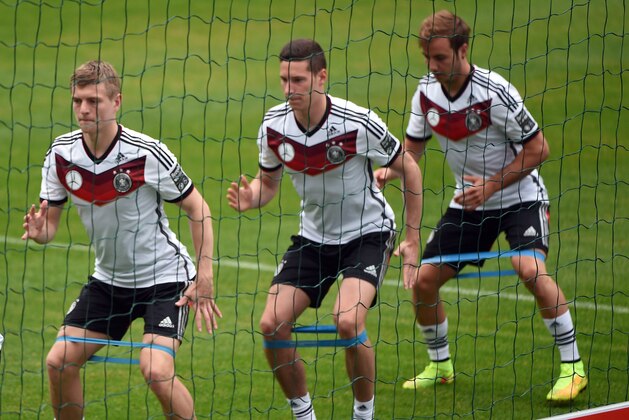 Germany´s midfielder Toni Kroos, Germany´s midfielder Julian Draxler and Germany´s midfielder Mario Goetze warm up during a training session of the German national soccer team on a training ground in San Martino in Passiria, Italy, on May 23, 2014. Germany 's squad prepares for the upcoming FIFA World Cup 2014 in Brazil at a training camp in South Tyrol until May 31, 2014  AFP PHOTO / PATRIK STOLLARZ        (Photo credit should read PATRIK STOLLARZ/AFP/Getty Images)