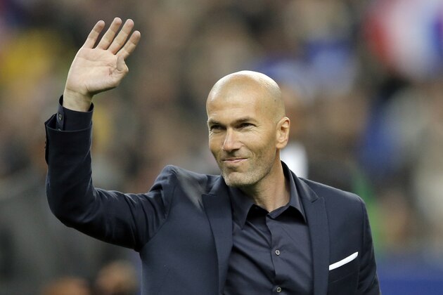 Former France's soccer player Zinedine Zidane waves to spectators prior to the international friendly soccer match between France and Brazil at the Stade de France, north of Paris, France, Thursday, March 26, 2015. (AP Photo/Francois Mori)